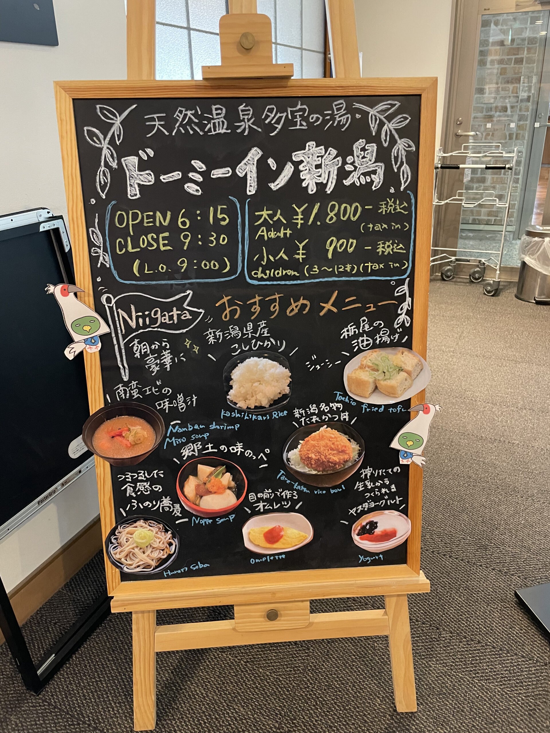 ドーミーイン新潟の朝食案内黒板｜たれカツ丼や南蛮エビの味噌汁など新潟名物の写真が並ぶ手書きのメニュー看板｜新潟県新潟市中央区
